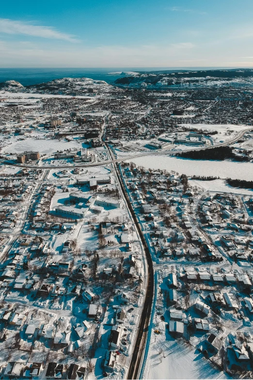 an aerial view of the town of a city, with snow in front of it