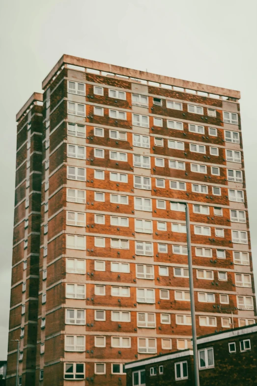 a brick building next to a road with lots of windows