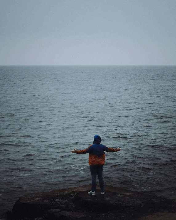 a man standing on top of a large body of water