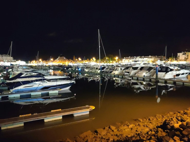 many small boats in a harbor on a night day