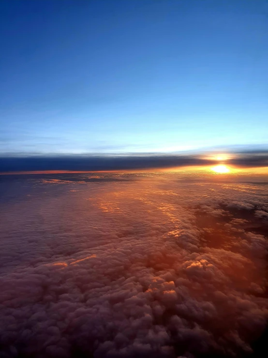 the sun shines on the water and land, taken from above