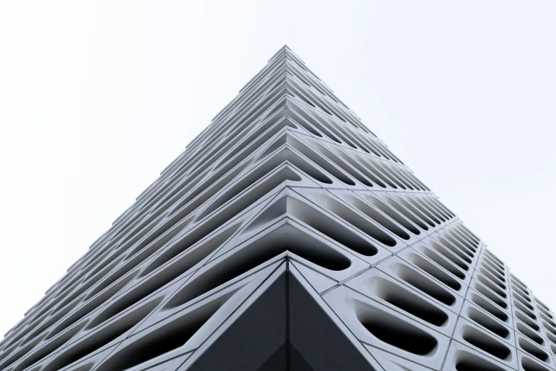 tall white building with curved windows and balconies