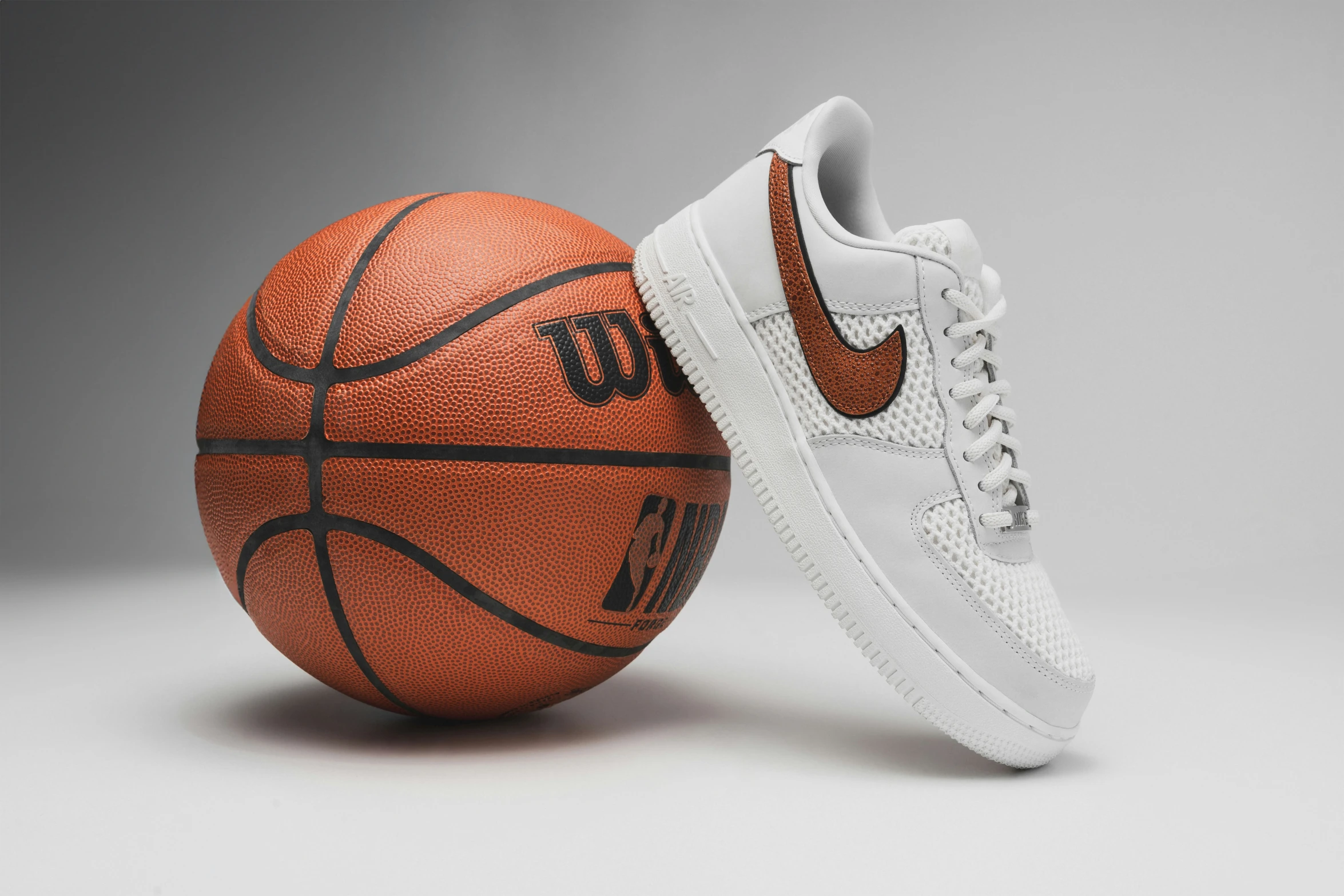 nike shoes are displayed beside a basketball