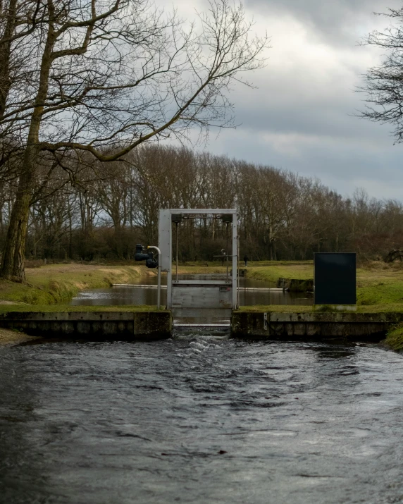 a body of water next to a dock with an enclosed structure