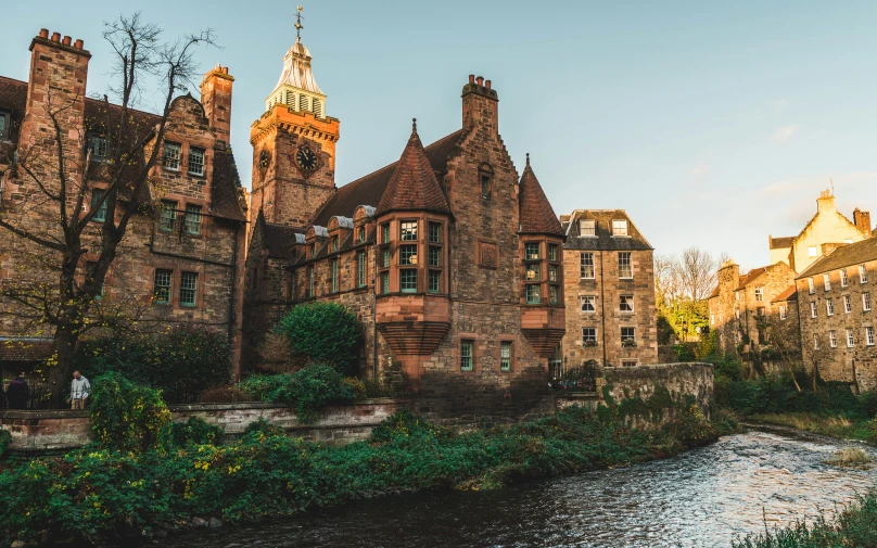 a building near a river and another structure behind it