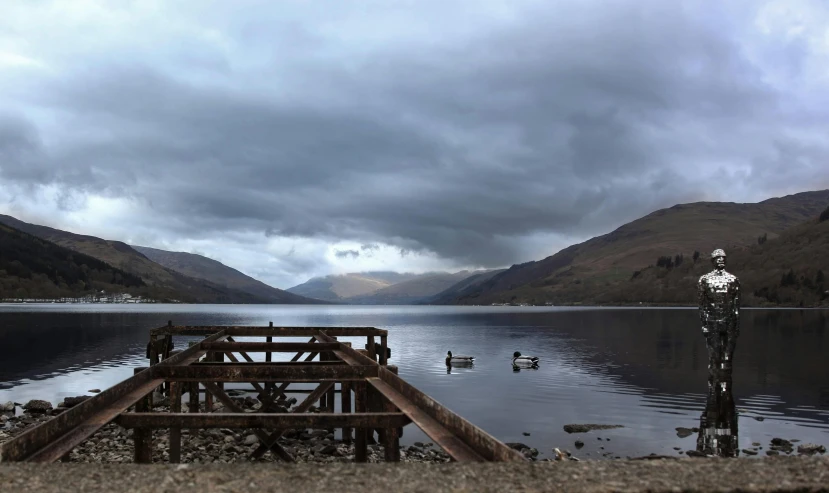 the dock at the side of the mountain overlooks a lake