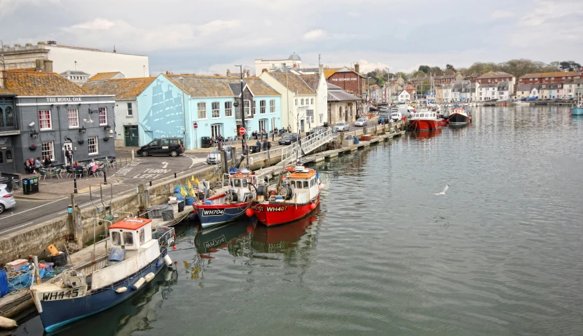 there are many boats on the water by some buildings