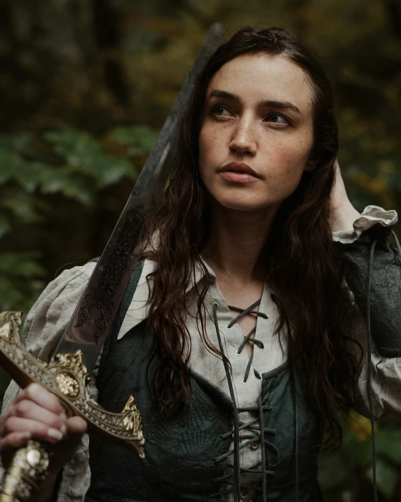 a woman in a medieval costume posing with her sword