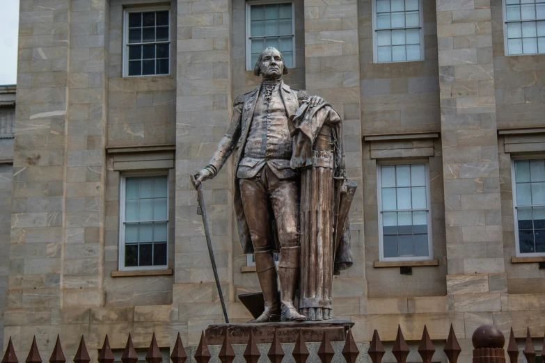 there is a statue on display outside of the building