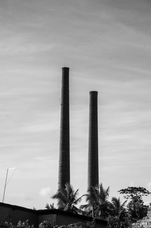 a black and white po of three tall chimneys