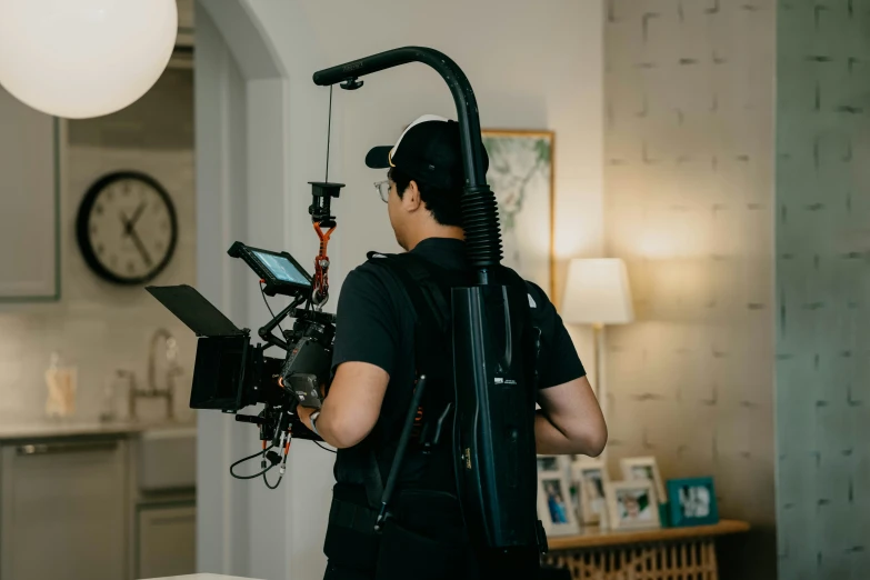 a man is in the kitchen fixing his camera