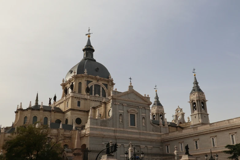 an ornate building with two clocks on each of the domes