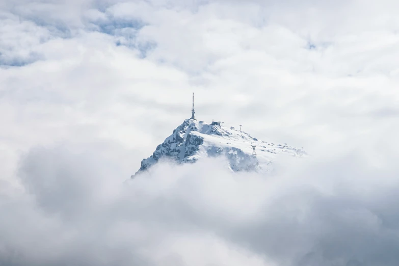 a cloud covered mountain on a bright sunny day