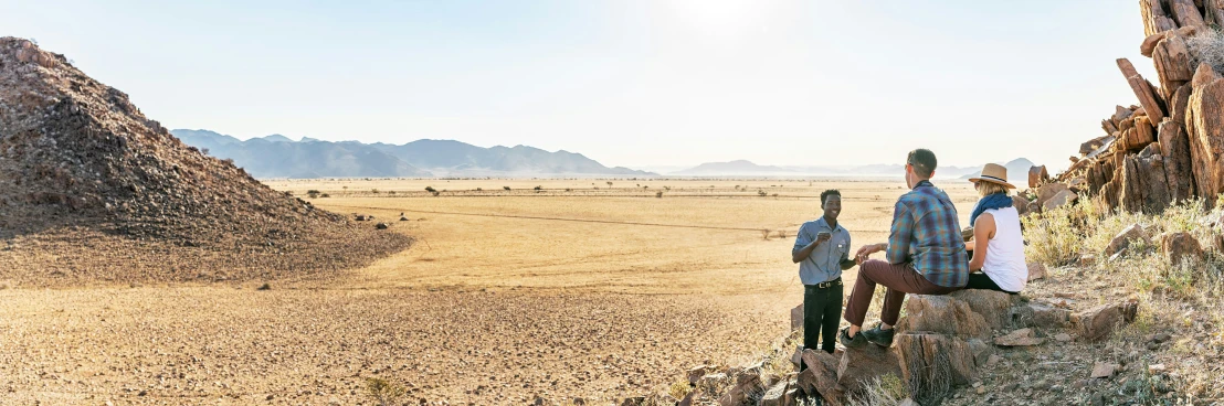 three people looking out over the desert