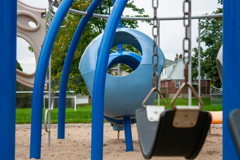 the playground is equipped with several colorful pieces of equipment