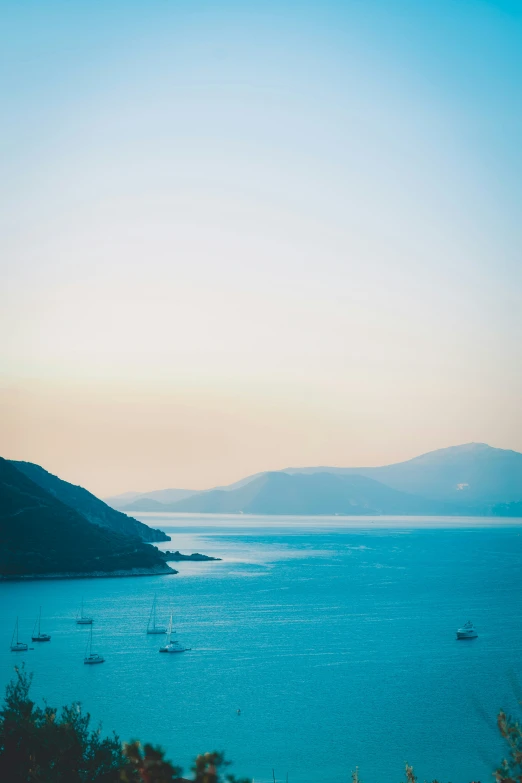 the boats are out in the water at sunset