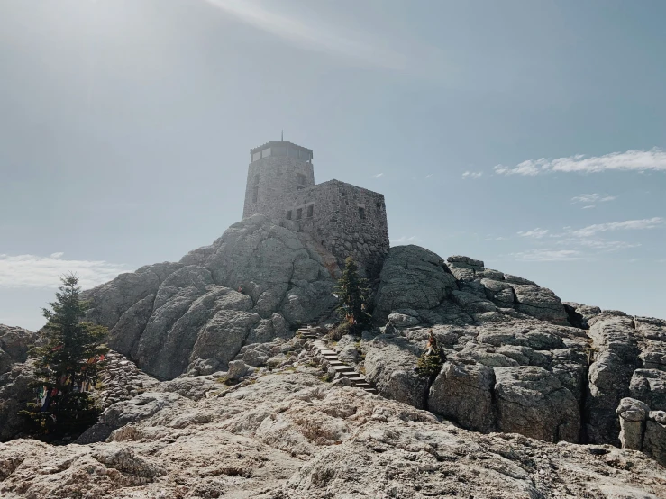 an image of a mountain top with a tower