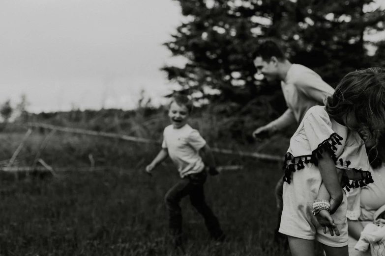 black and white po of people playing frisbee