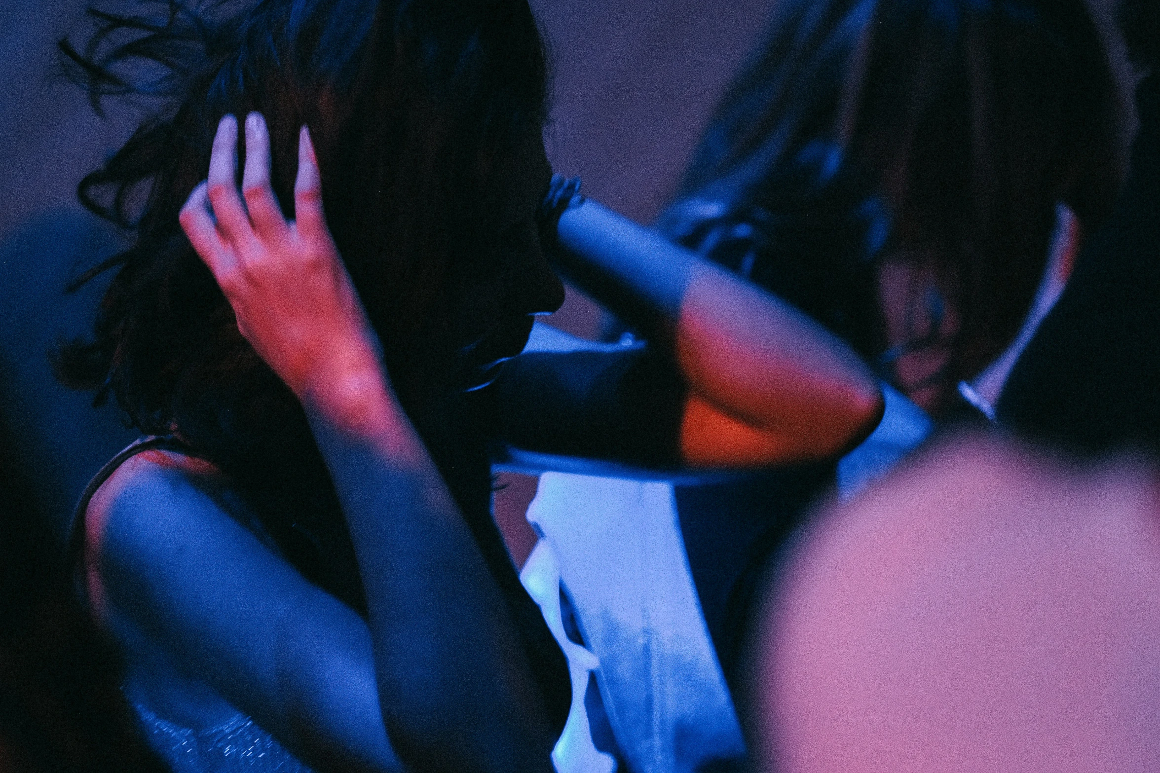 two women sitting in front of each other talking