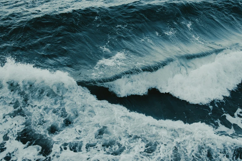 a blue and white po with white foam in the water