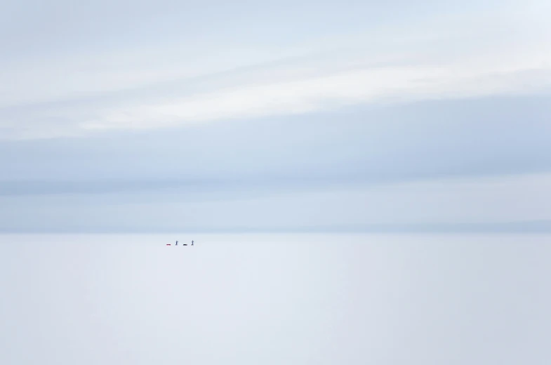 people are standing in water on a cloudy day