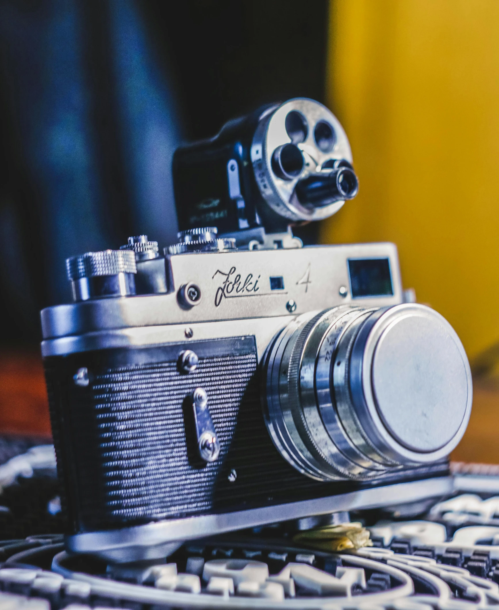 an old camera is next to an old film roll