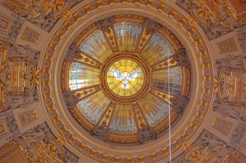 a clock and decorative decorations on the ceiling of a dome