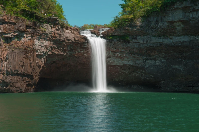 a waterfall that has been falling into the water