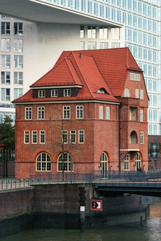 a bridge crosses over the river in front of buildings