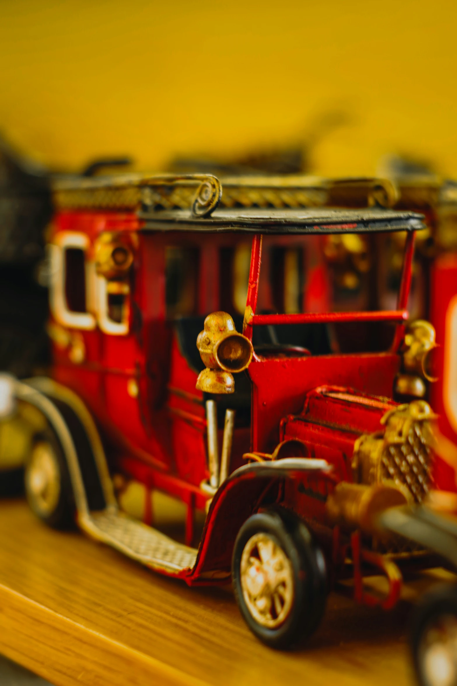 an old fashioned toy fire truck with gold trimming