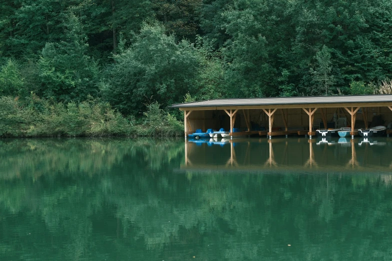 a boathouse with two blue kayaks is shown