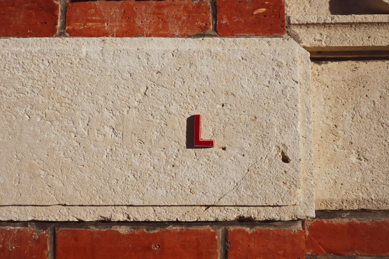 a close up of a cement block wall with a single light switch