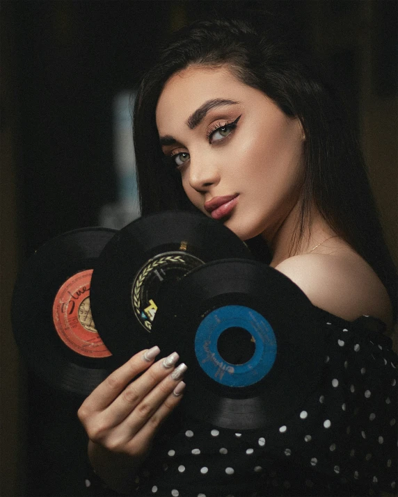 woman holding records and looking into the camera