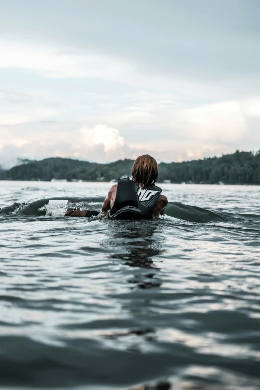 a person swimming in the water while using a laptop