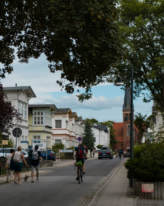 some people are riding bikes down a quiet street