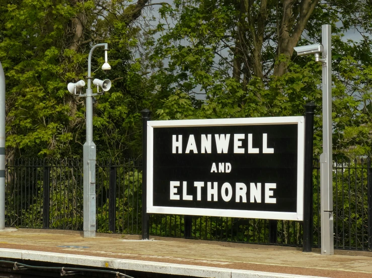 a sign posted on a dock with trees in the background