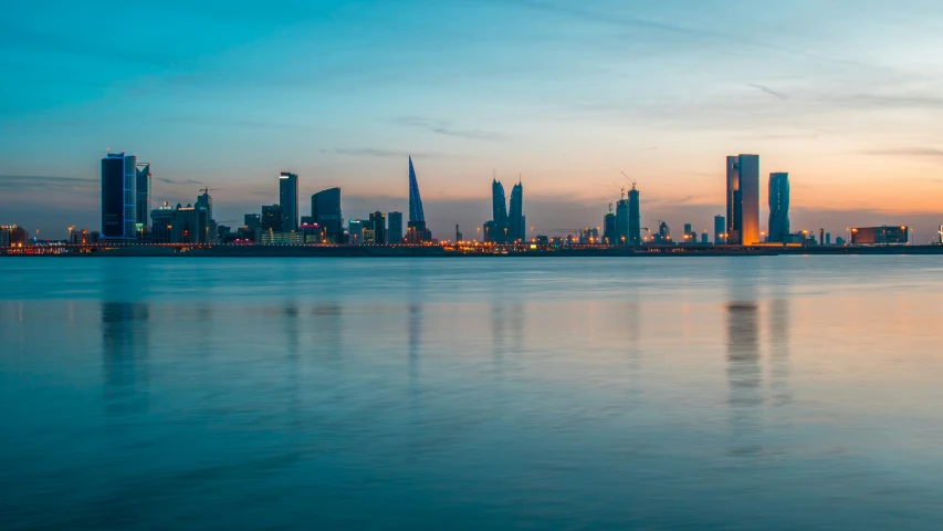 an orange sunset is seen in the back ground of a city skyline with many high rise skyscrs in the distance