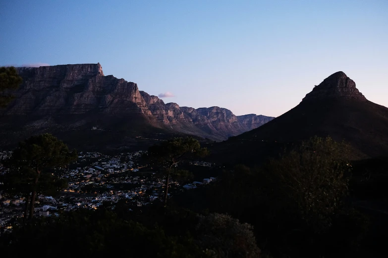 a distant view of a city below the mountains