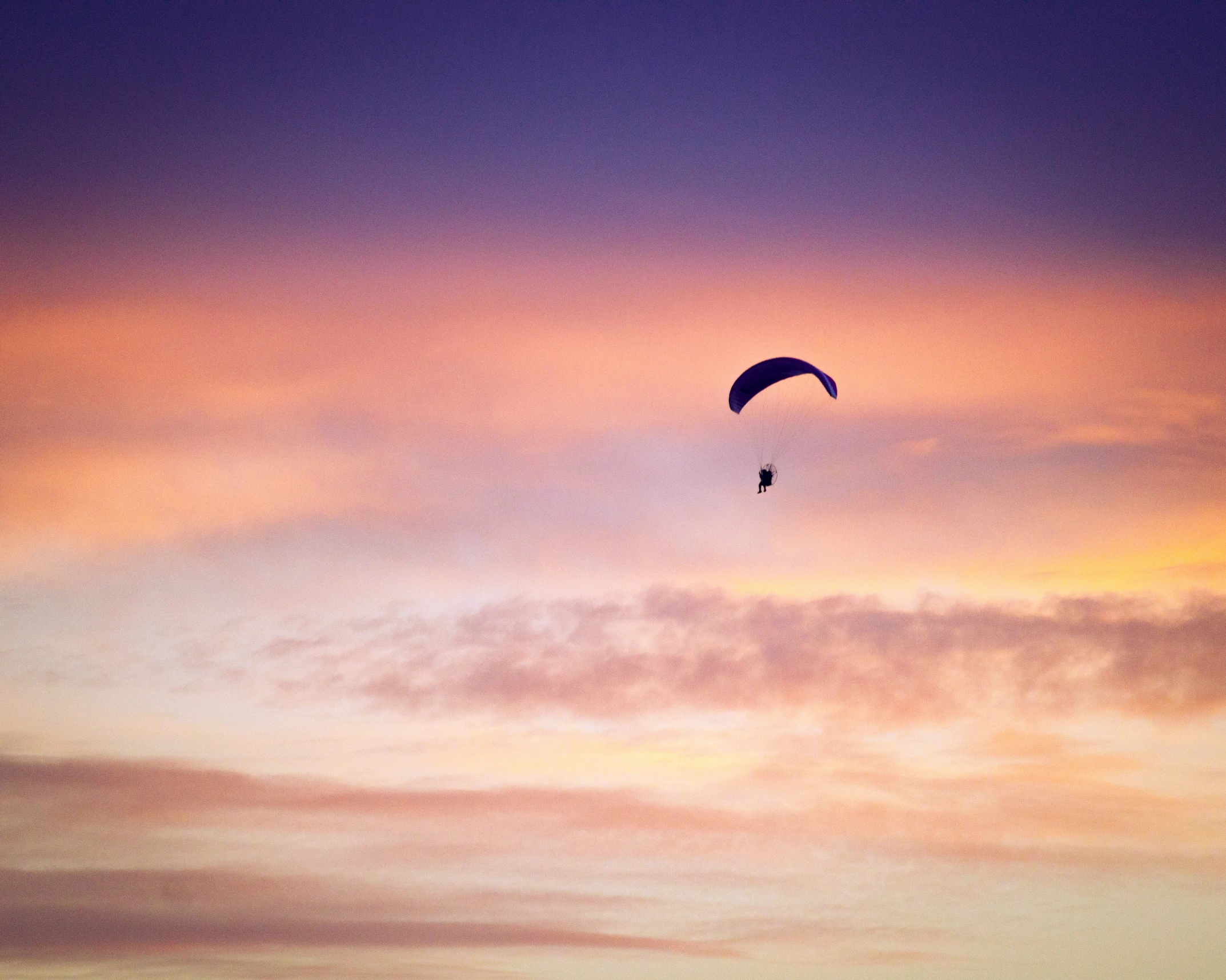 a couple of people parasailing at the beach