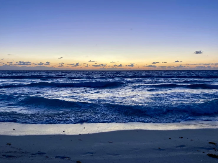 the view of the beach and ocean from the shoreline