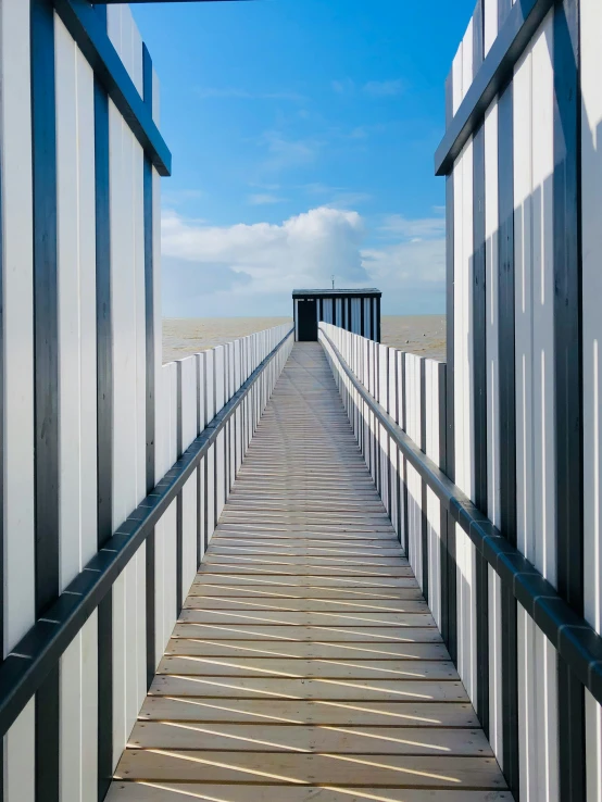 a bridge leading to the ocean is very tall