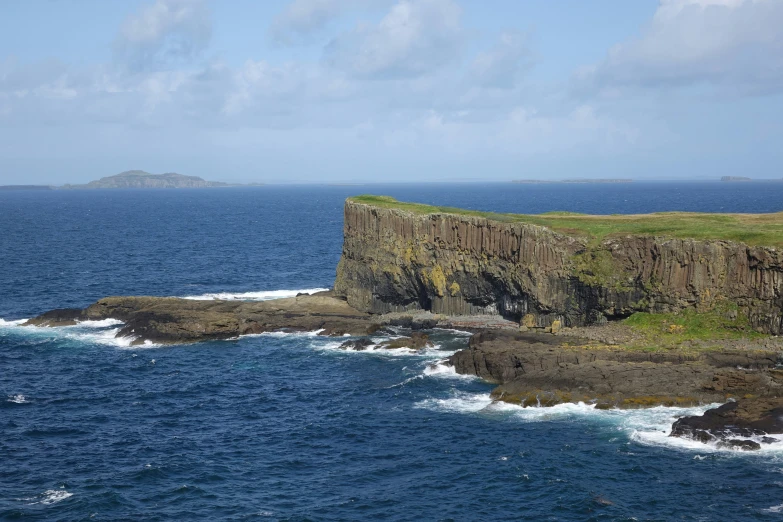 an island off of the coast in the middle of the ocean