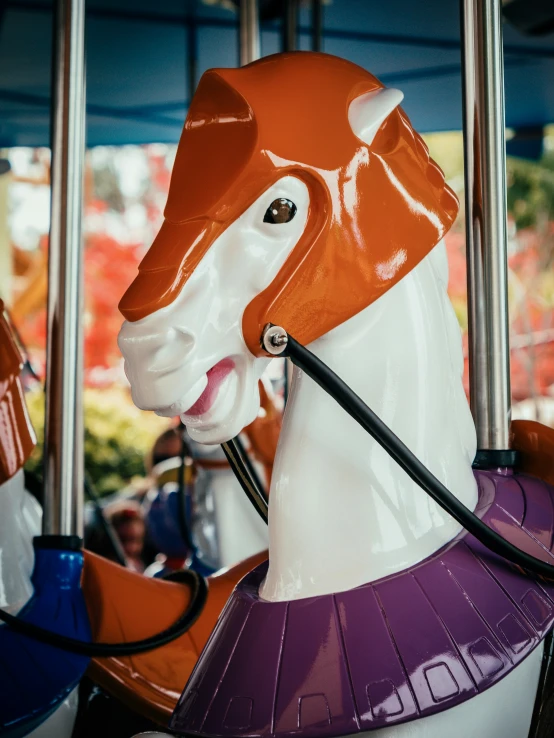 a horse statue sitting in front of a colorful wall