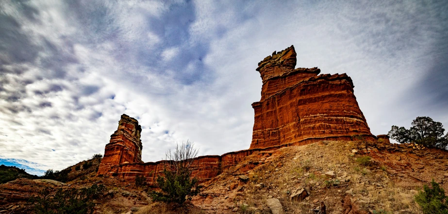 rocks on top of the mountain and a cloudy sky in the distance