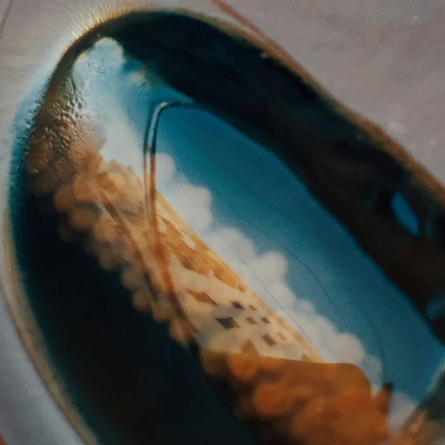 the reflection of an umbrella in a dle of water