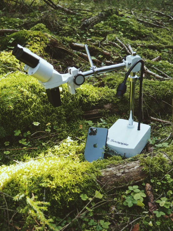 a camera and a large object in the green ground