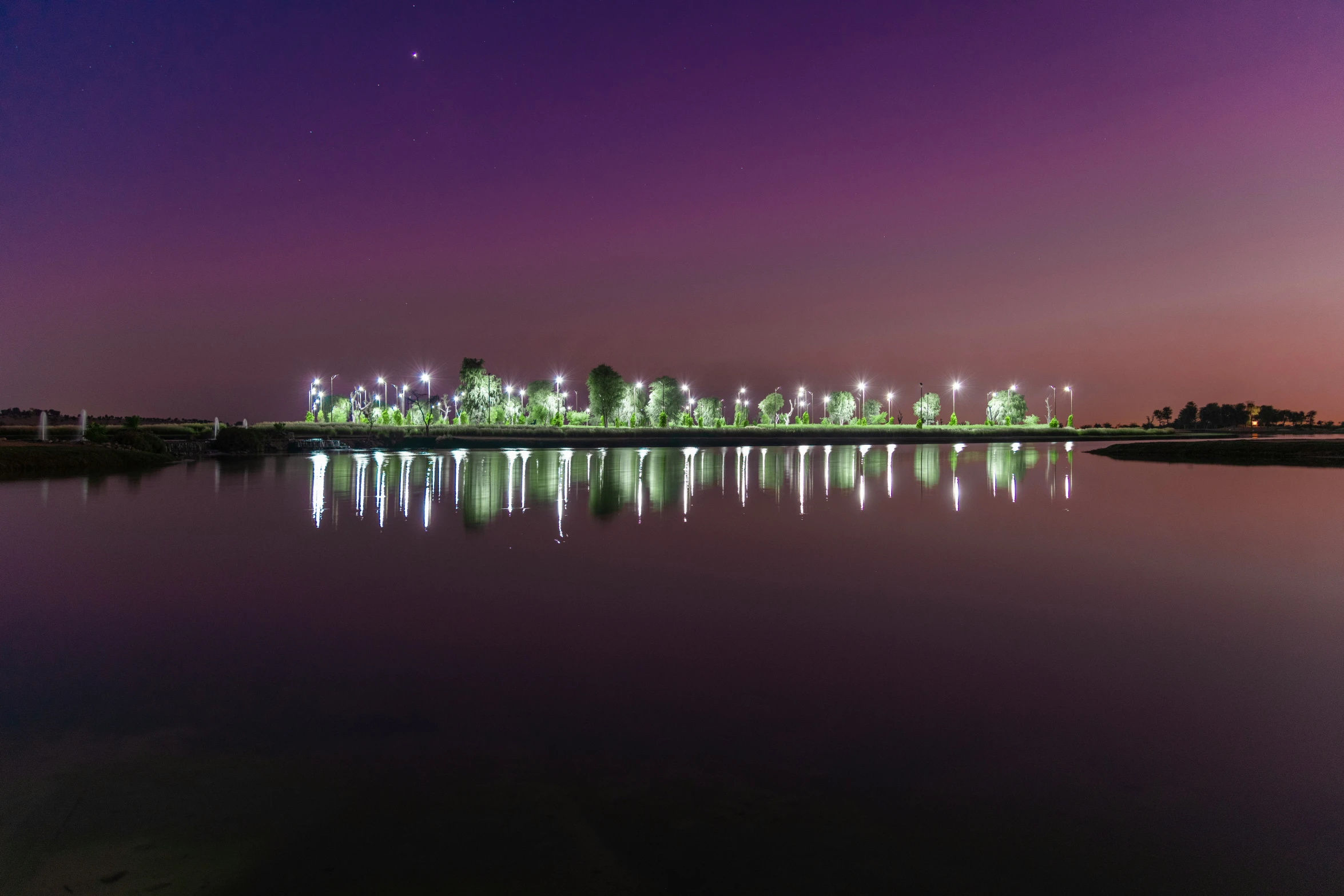 a nighttime po taken from a dock overlooking the city