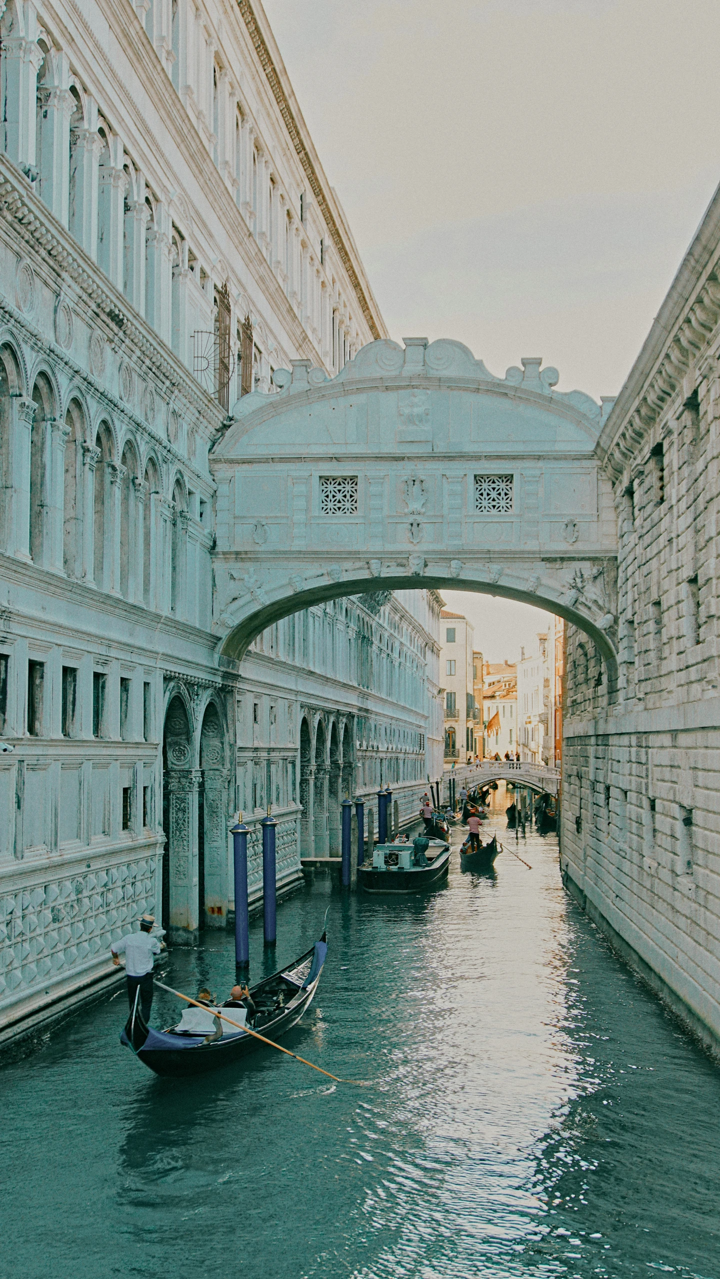 a waterway runs underneath an arch that has arches and windows