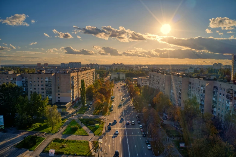 the sun shining over some city with many buildings