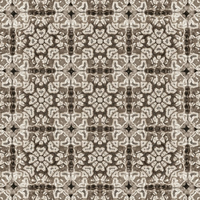 a brown and white flower on a patterned fabric